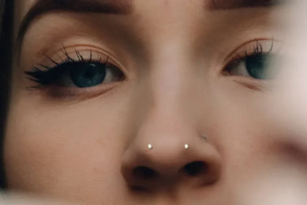 A woman wearing understated mantis-themed piercing jewelry